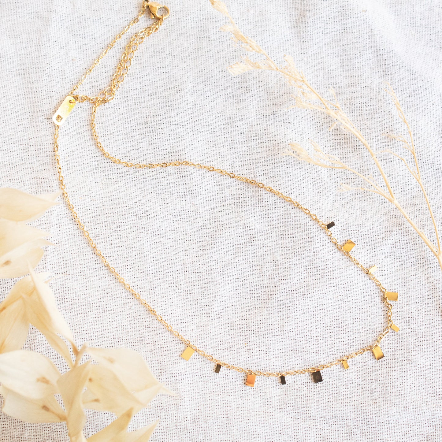 Gold delicate necklace with scattered square charms