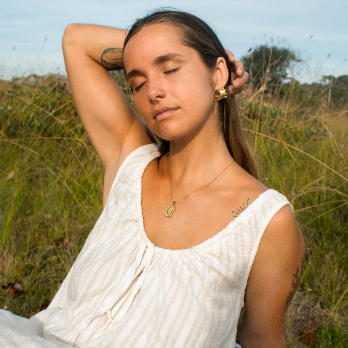 Gold celestial necklace on woman