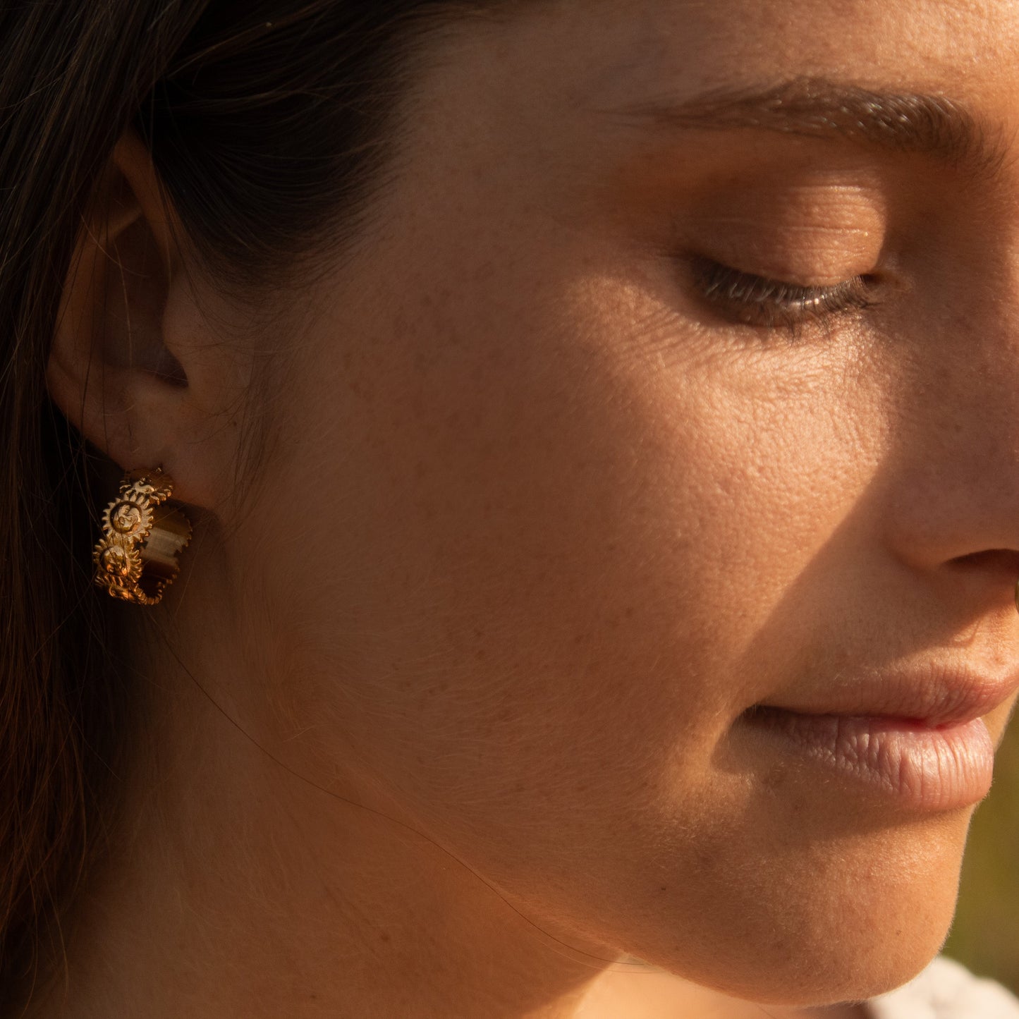 Gold hoop earrings with floral detail