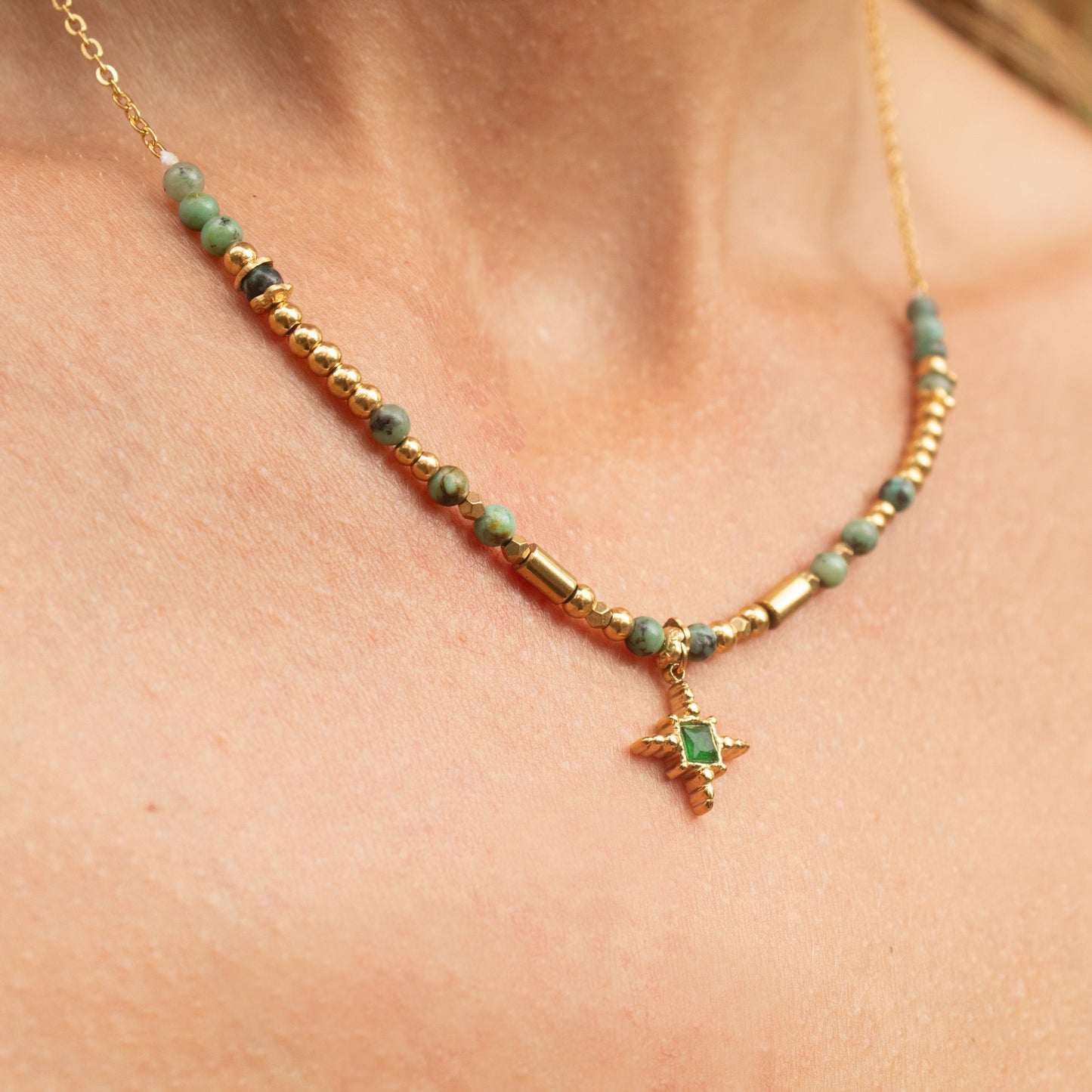 Gold necklace with emerald star pendant