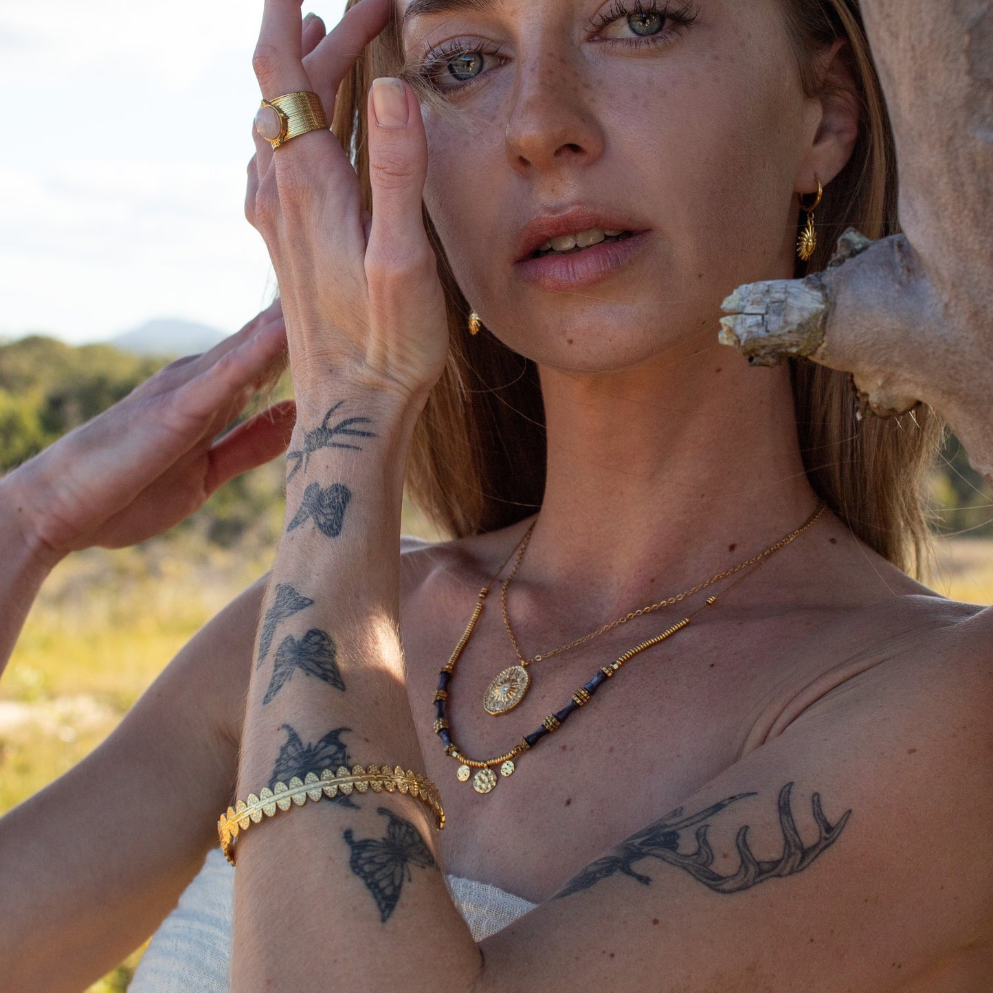 Gold Cosmic Aura necklace with blue beads
