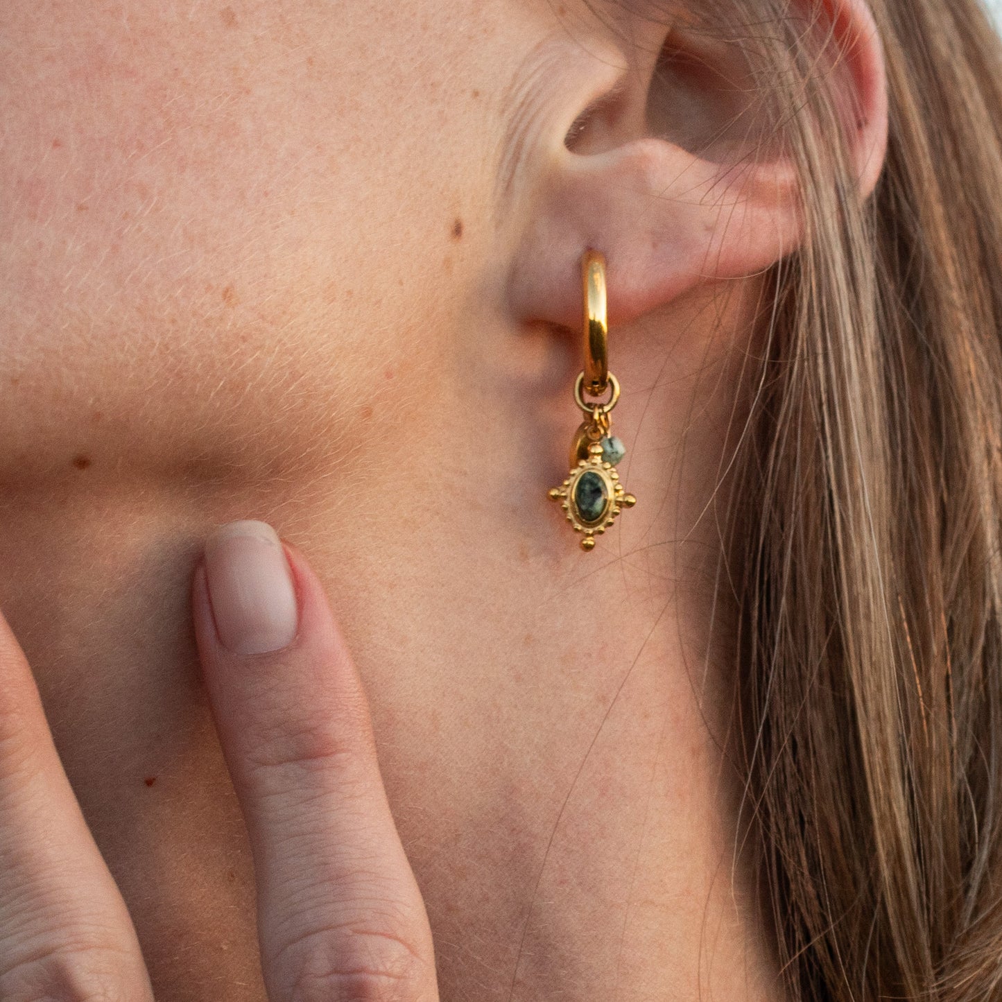 Amara Light gold earrings with green stone charm