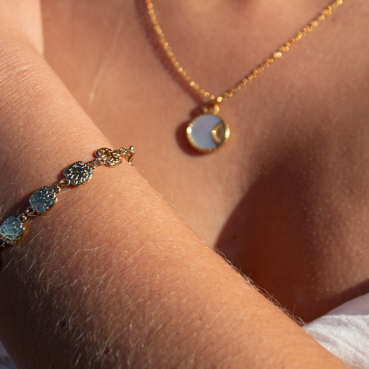 Gold necklace with mother of pearl pendant