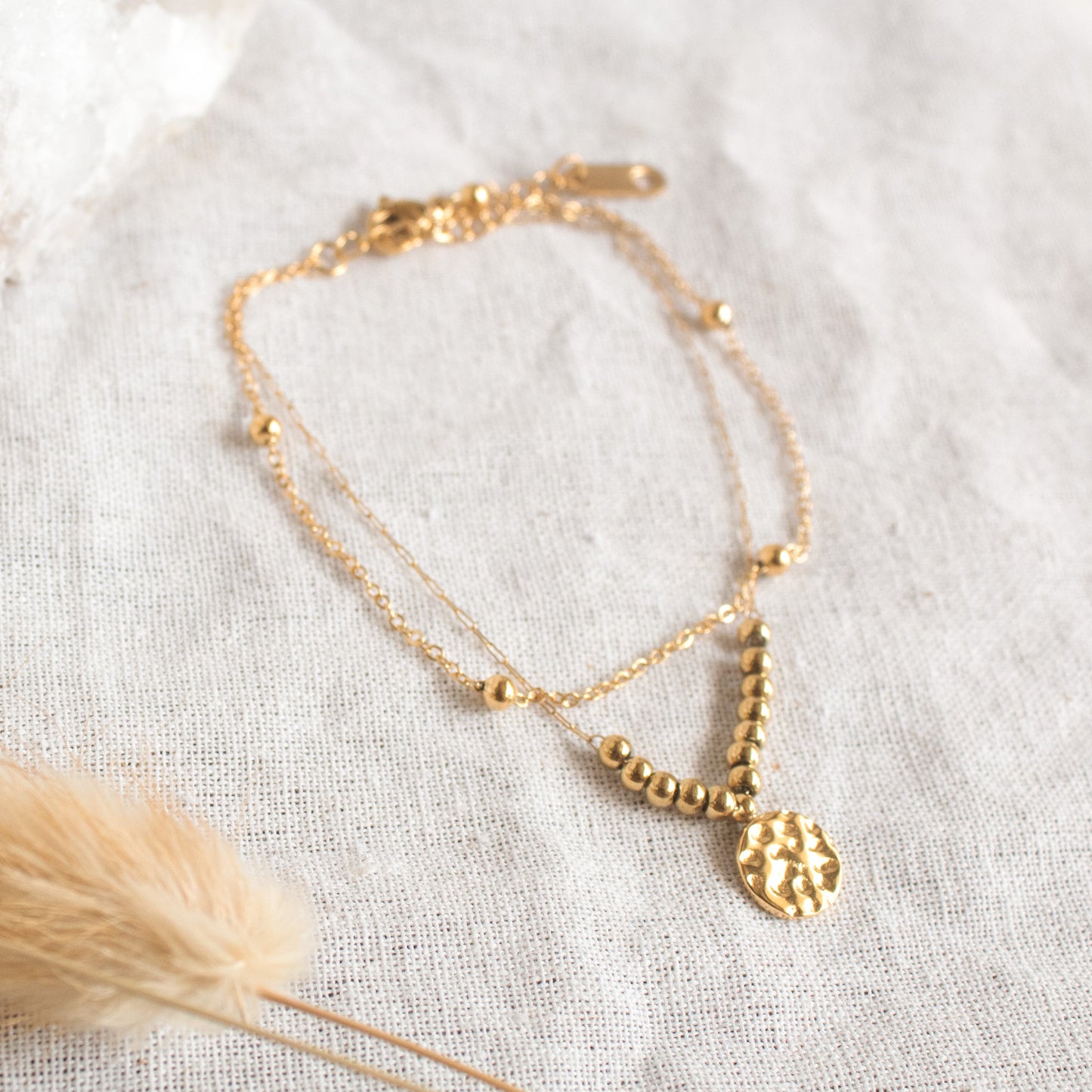 Gold double-layer bracelet with hammered pendant