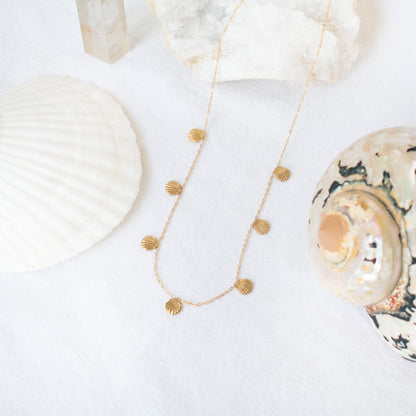 Gold necklace with seashell charms