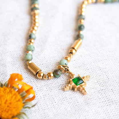 Gold necklace with green beads and emerald star pendant