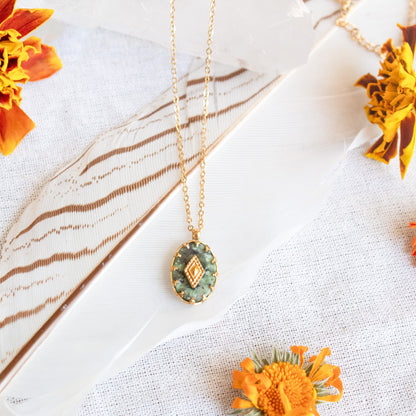 Transformation Necklace with green stone and gold detail