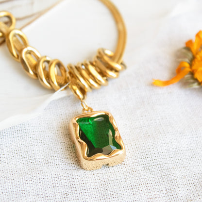 Gold necklace with green emerald pendant
