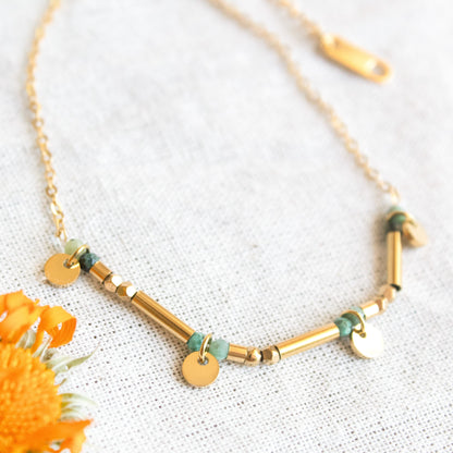Gold necklace with green stone beads and discs