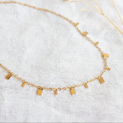 Gold necklace with dangling square charms