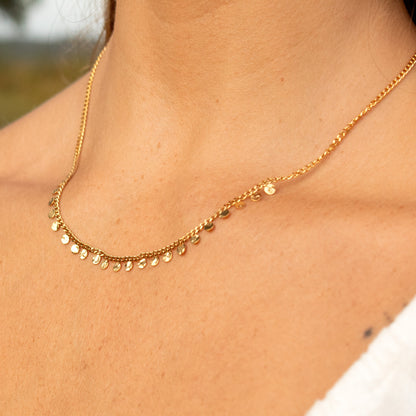 Gold necklace with scattered disc charms