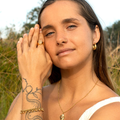 Gold beaded bracelet with charms
