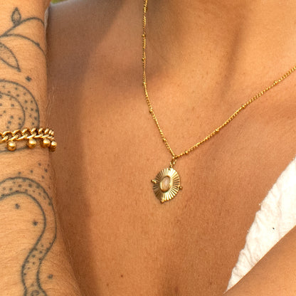 Gold sunburst pendant necklace with opal accent