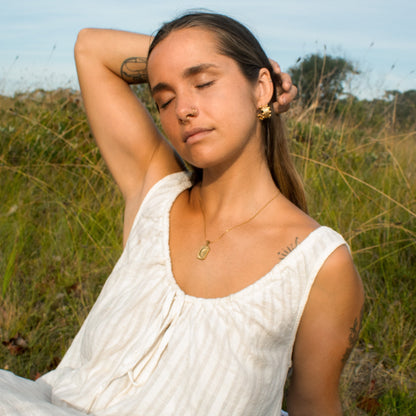 Gold celestial necklace on woman