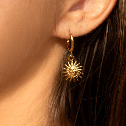 Gold sun charm hoop earrings