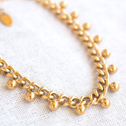 Gold chain bracelet with dangling charms