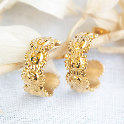 Gold sun deity hoop earrings