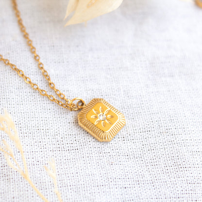 Gold square pendant necklace with sunburst design