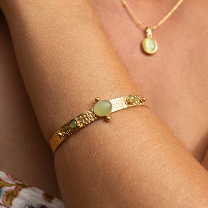 Gold bangle with green jade stones