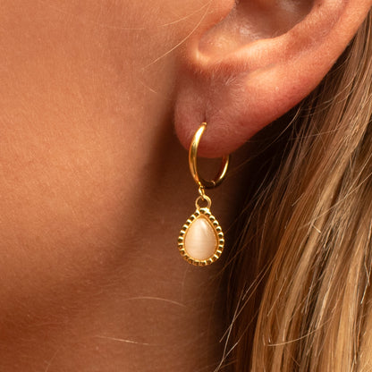 Gold hoop earrings with pink opal droplet charm