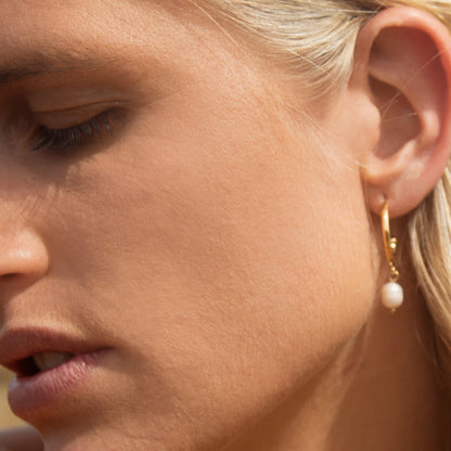 Gold hoop earrings with pearl drop