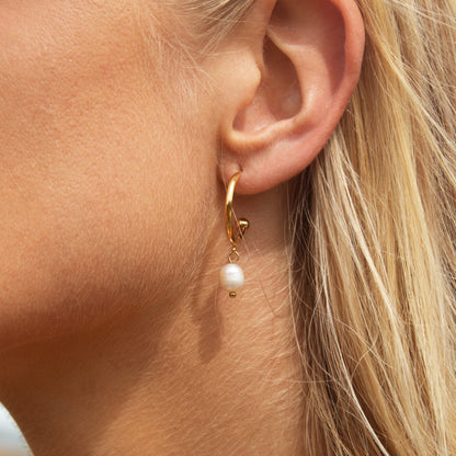 Gold hoop earrings with pearl drop