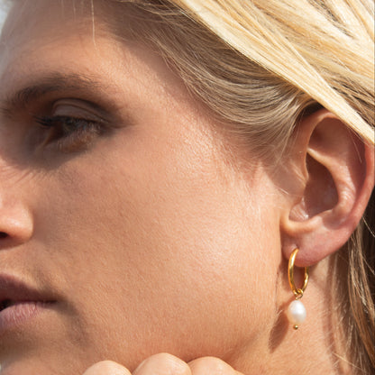 Gold hoop earrings with pearl drop