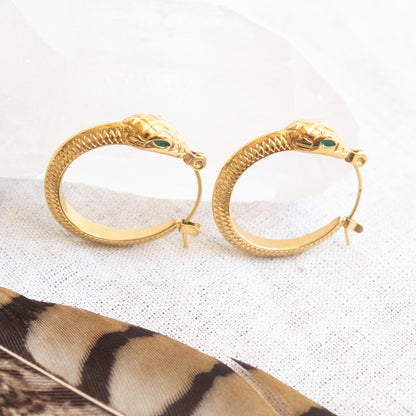 Gold Ouroboros snake hoop earrings with green eyes