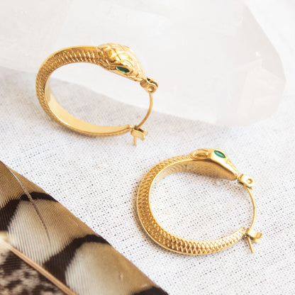 Ouroboros snake hoop earrings with emerald eyes