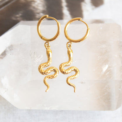 Gold hoop earrings with dangling snake charms