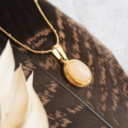Pink Orbis necklace on feather