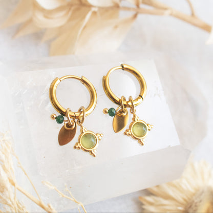 Gold hoop earrings with green gems and charms