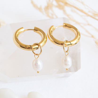 Gold hoop earrings with pearl drops