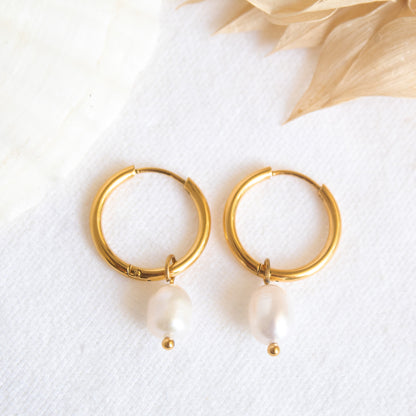 Gold hoop earrings with pearl drops