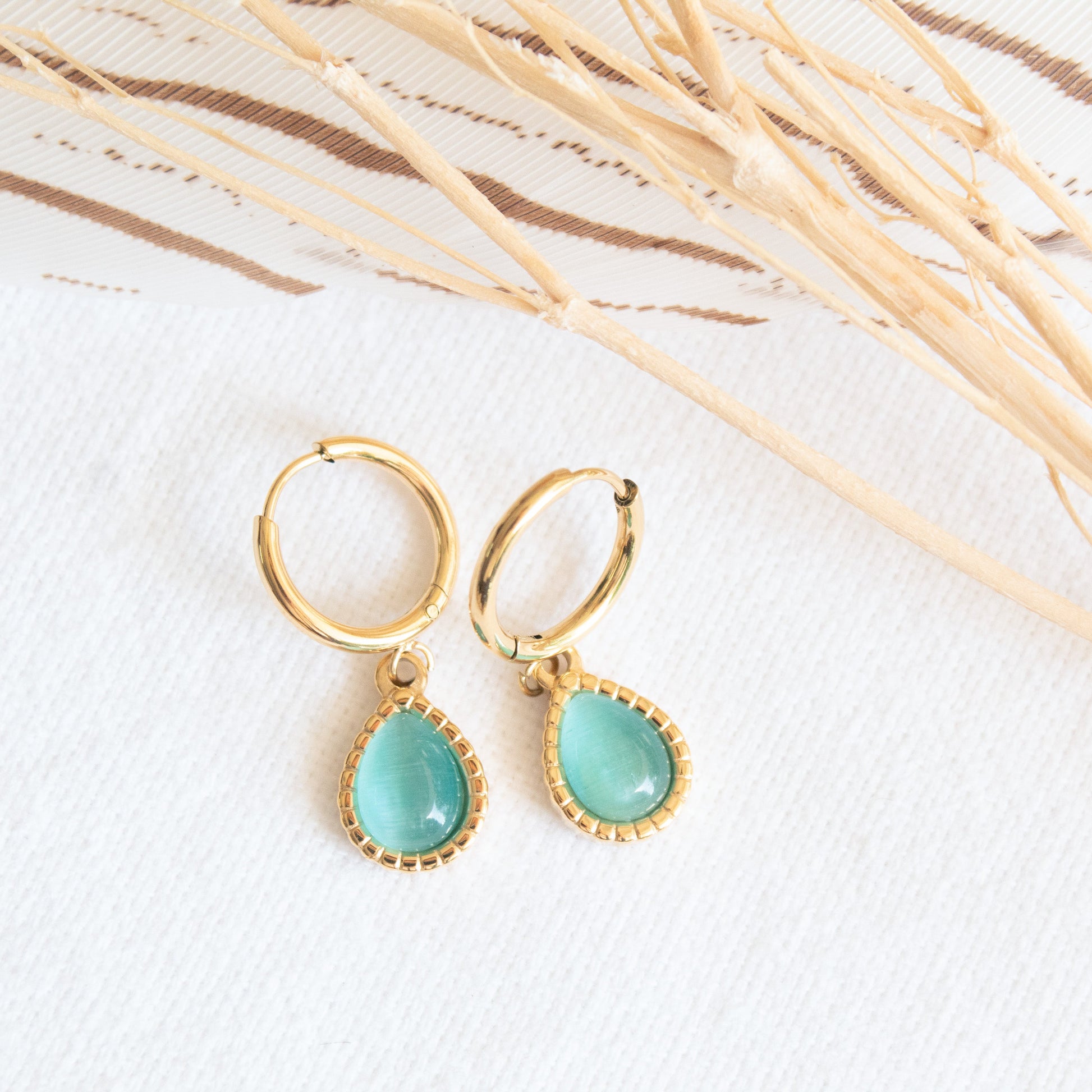 Gold hoop earrings with blue opal droplet charms