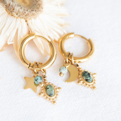 Gold hoop earrings with star, moon, and stone charms