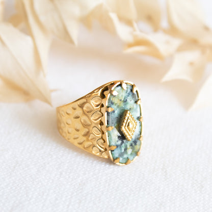 Gold ring with green stone and diamond detail