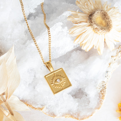 Gold square pendant necklace with eye design