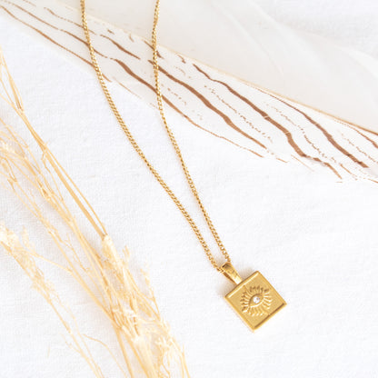 Gold square pendant necklace with sun design