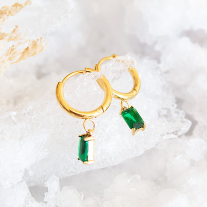 Gold hoop earrings with green emerald drop