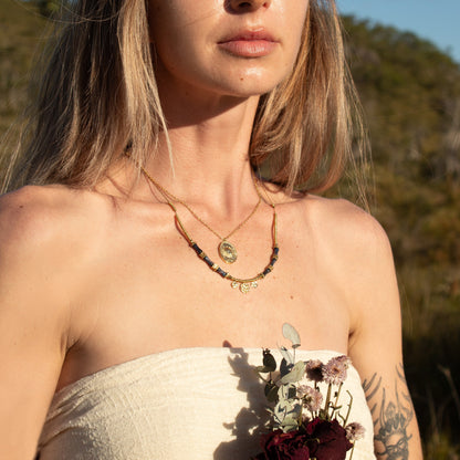 Gold Etheria Necklace with blue beads and charms