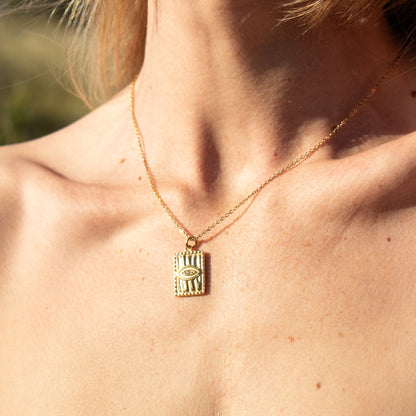 Gold rectangle pendant necklace with eye detail