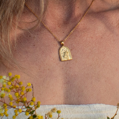 Gold Oasis necklace with palm tree and star design