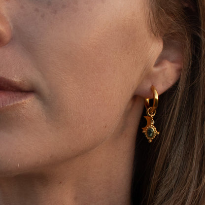 Gold hoop earrings with moon and green gem charm