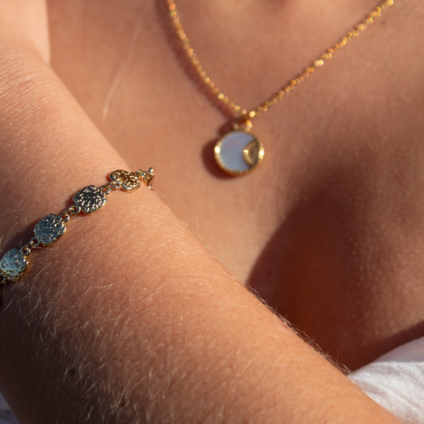 Gold necklace with mother of pearl pendant