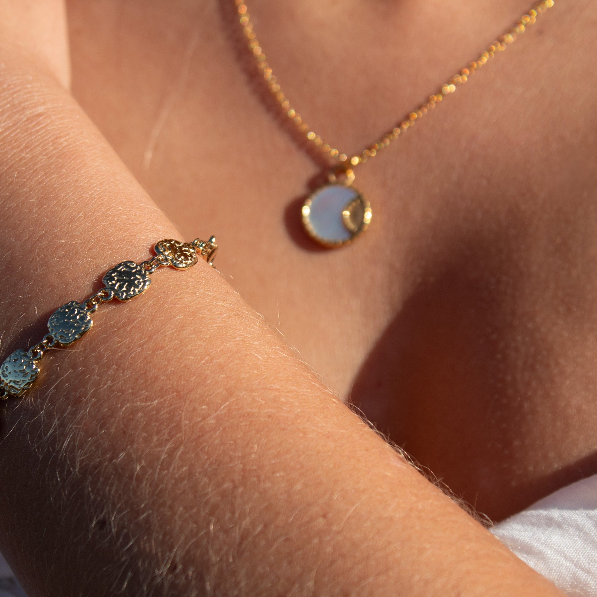 Gold necklace with mother of pearl pendant