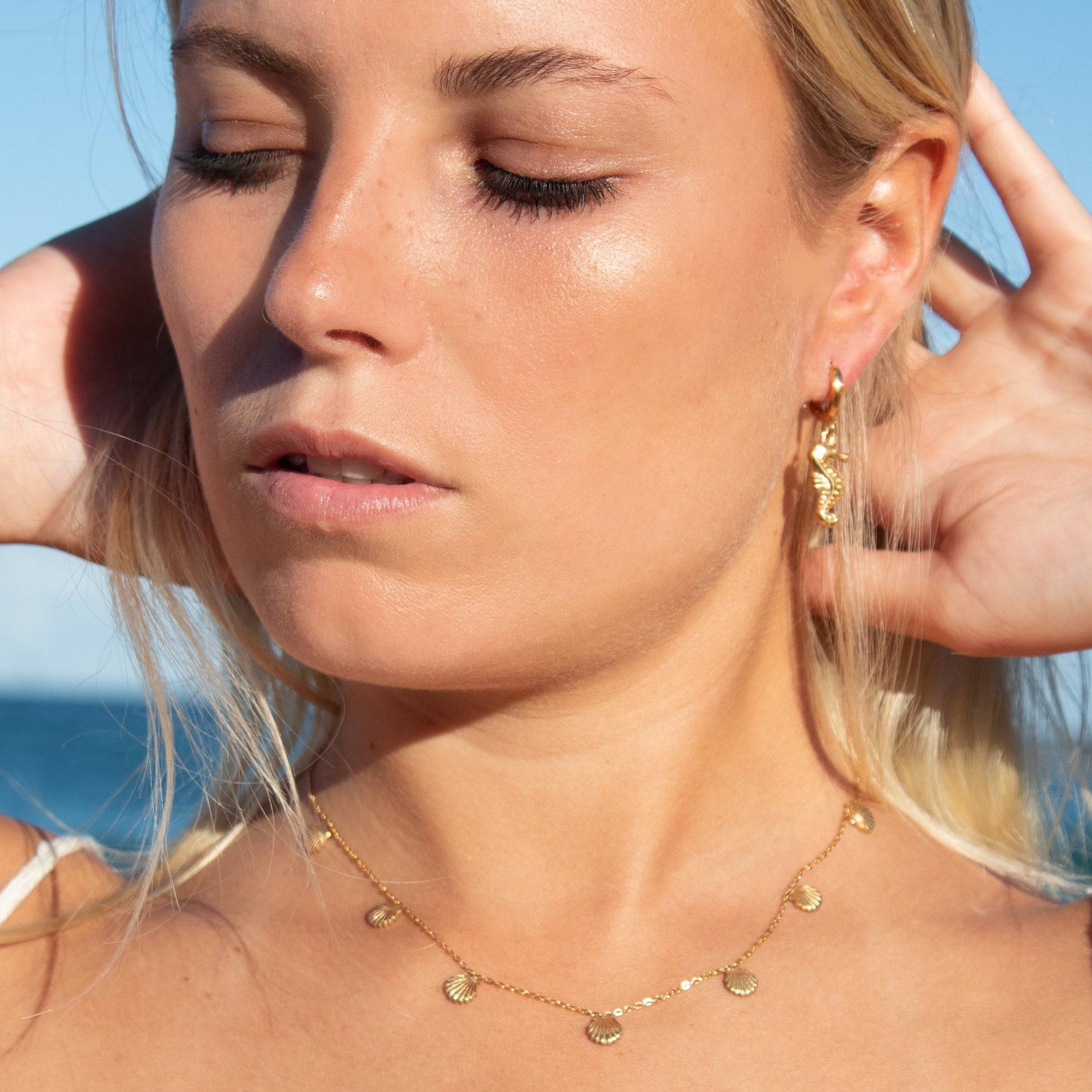 Gold seashell necklace and seahorse earrings