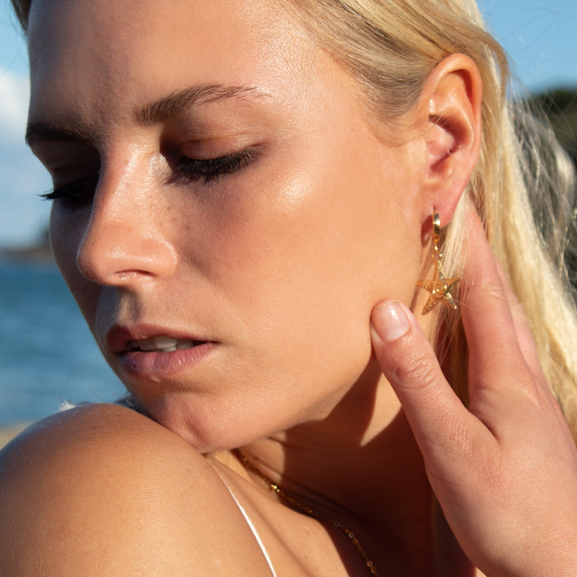 Gold starfish swirl earrings