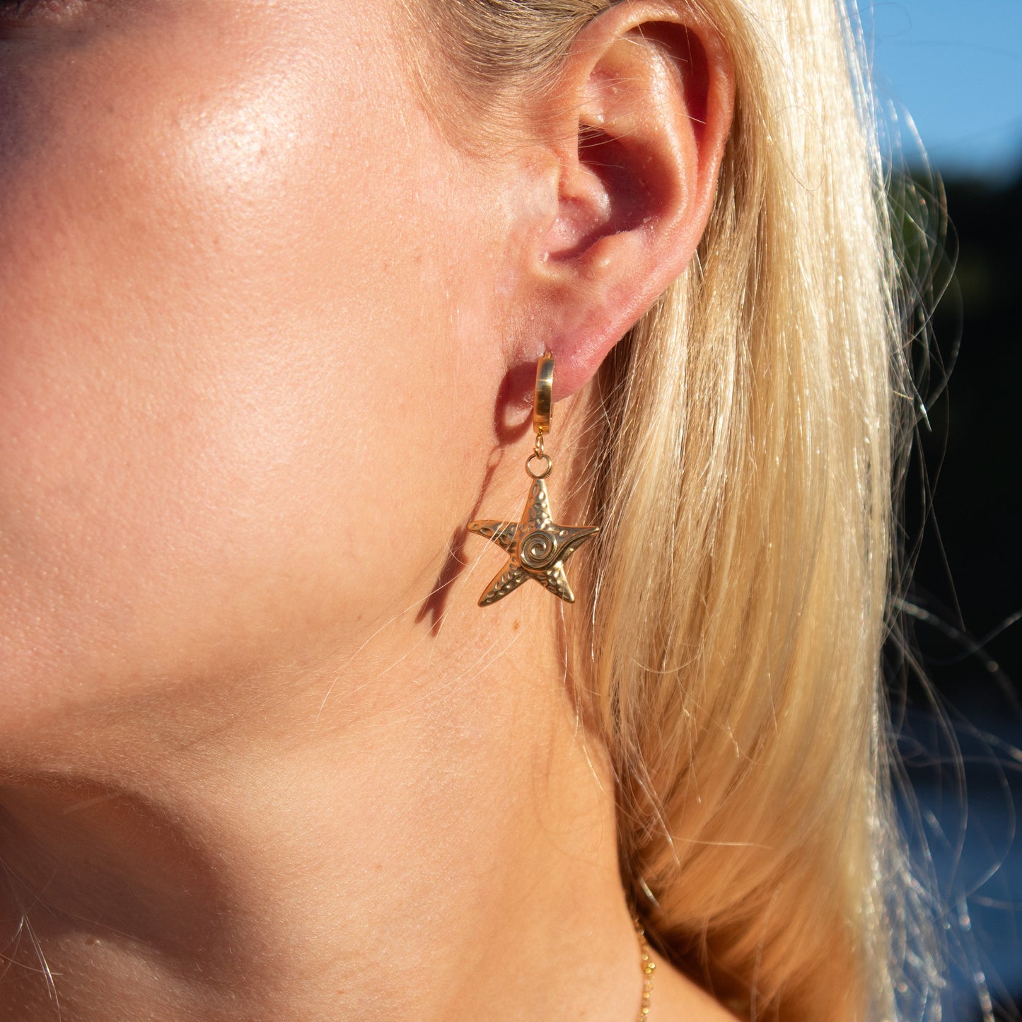 Gold starfish swirl dangle earrings
