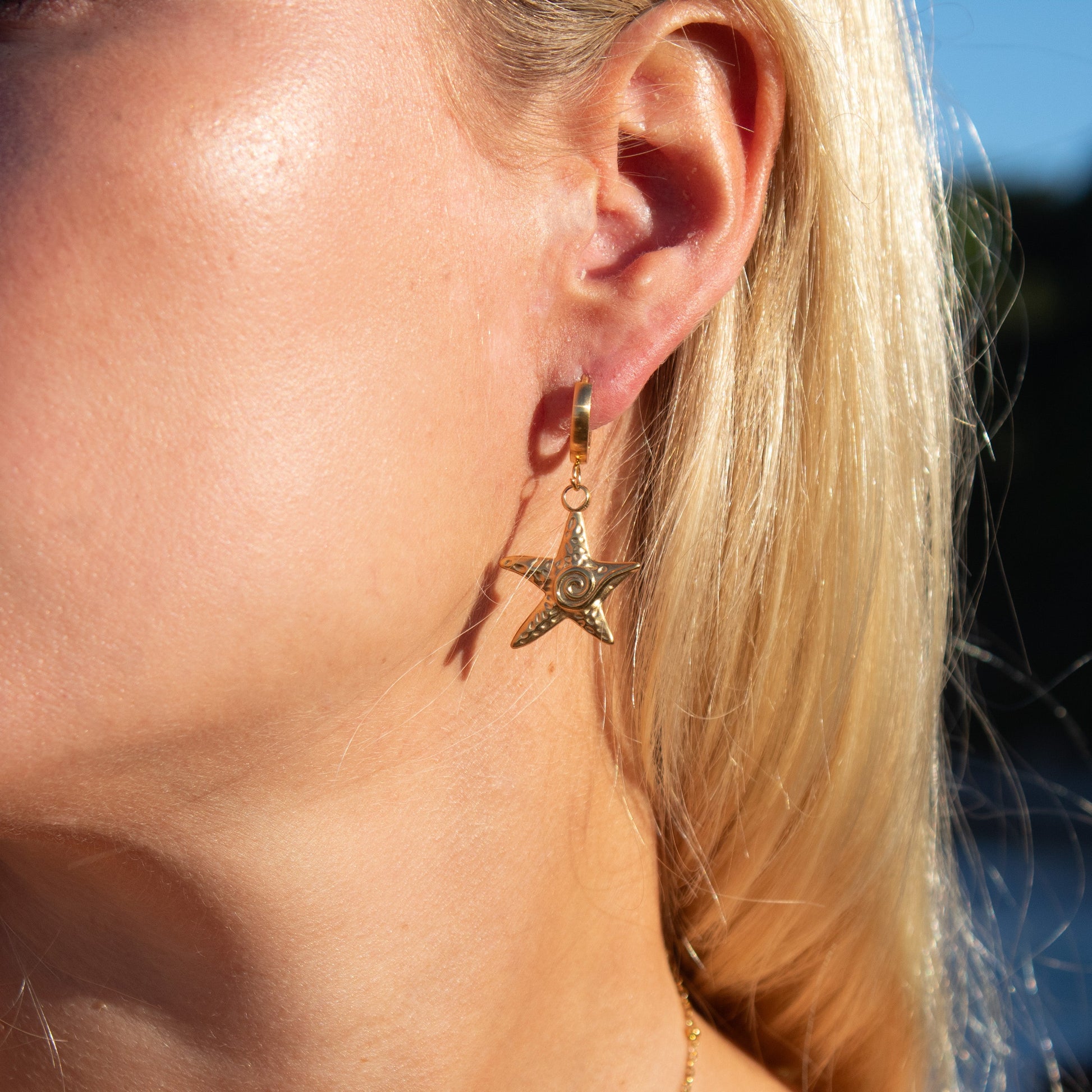 Gold starfish swirl dangle earrings